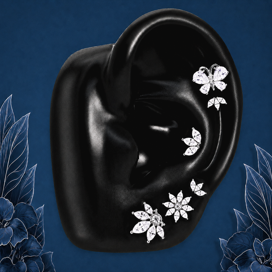 IMBER Enchanting earring stack in silver sterling silver with butterfly and floral studs, on display