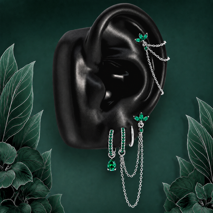 IMBER Eternal Green earring stack in silver titanium with green stones and chains, on display