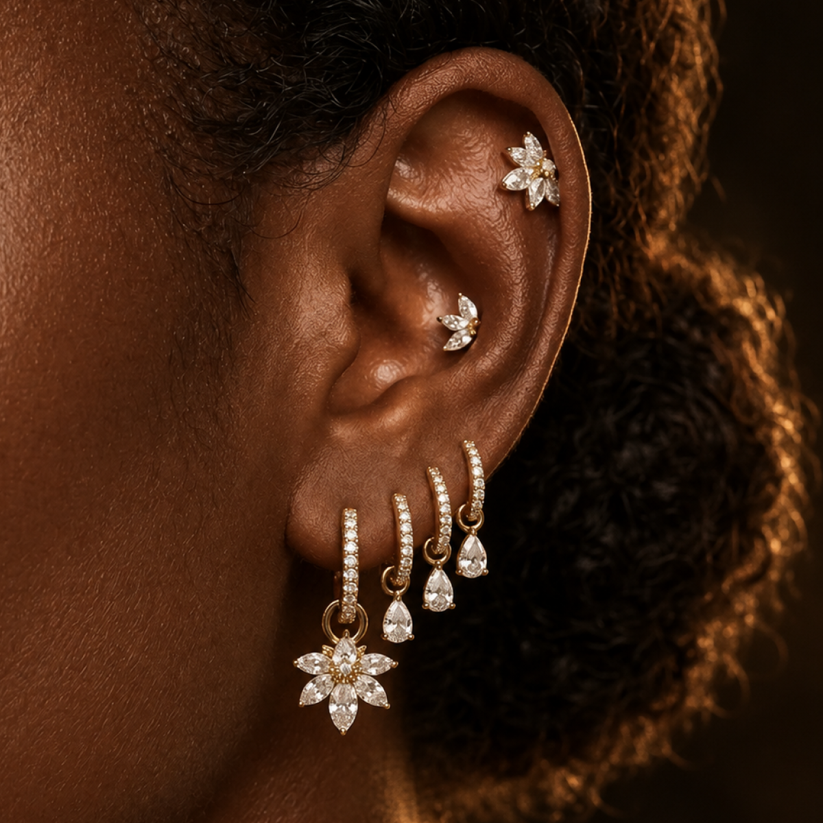 IMBER titanium florals and pear hoops layered on ear