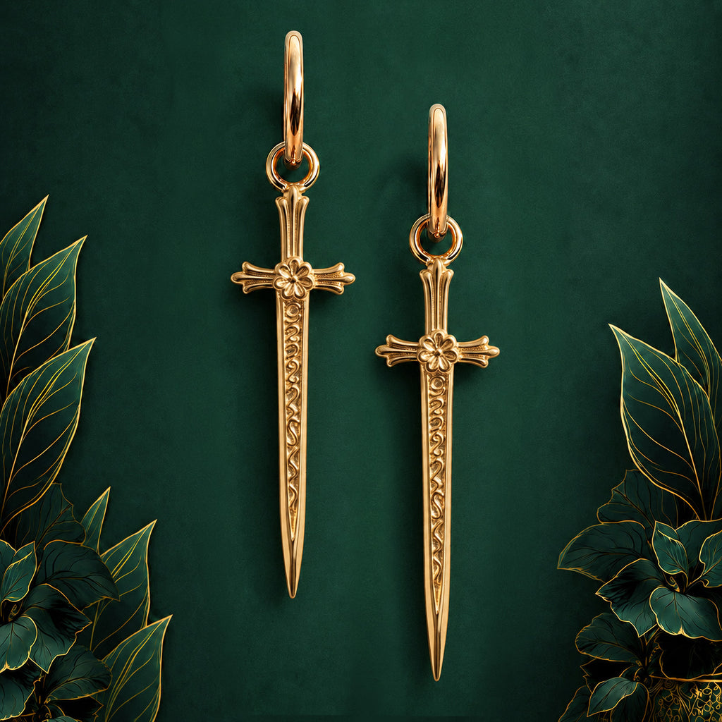 IMBER Apex Sword Huggies in gold titanium with sword drops, pair on display
