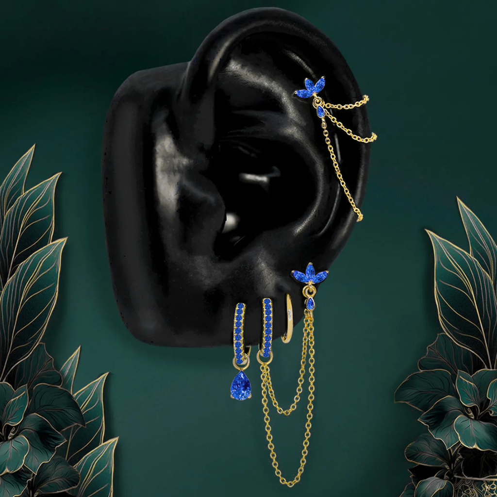 Dainty blue earrings styled in a modern earring stack with titanium hoops and studs.