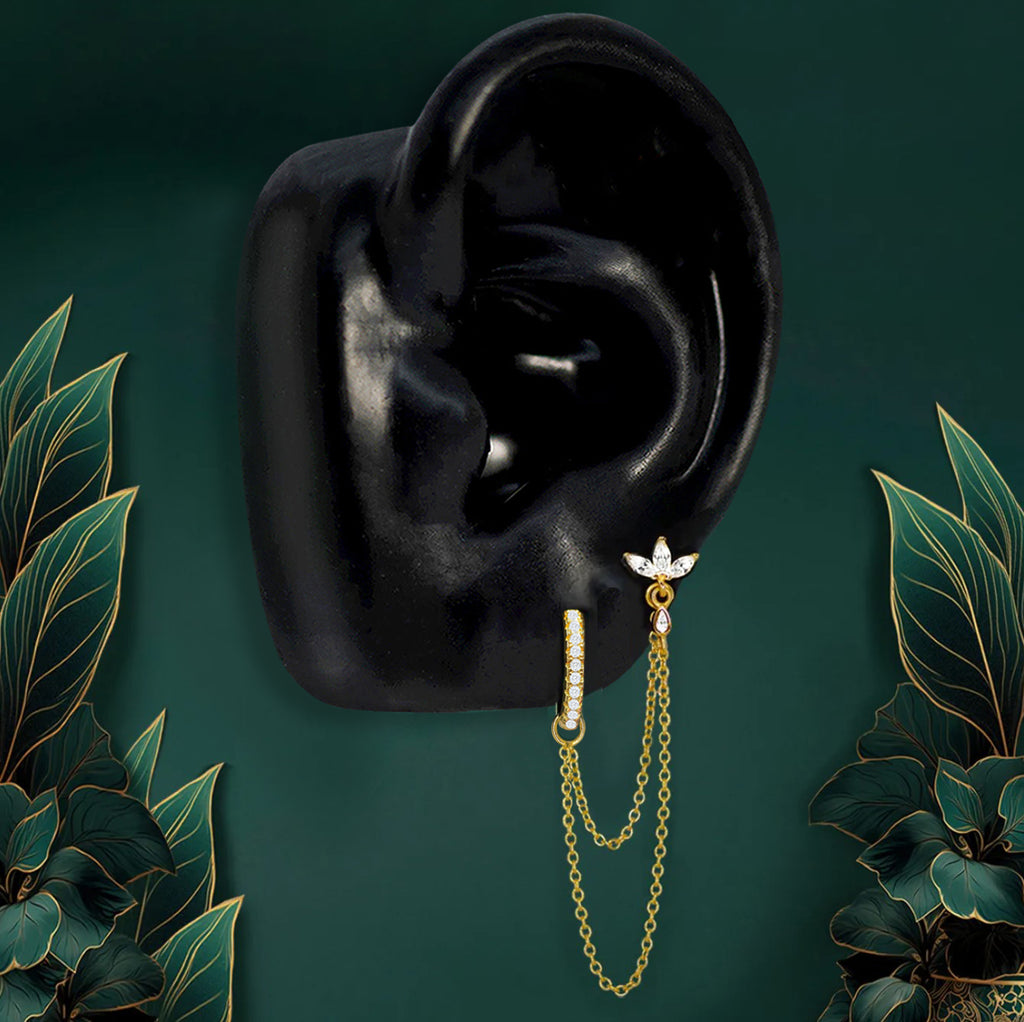 Gold double piercing earrings with clear white gem and chain design