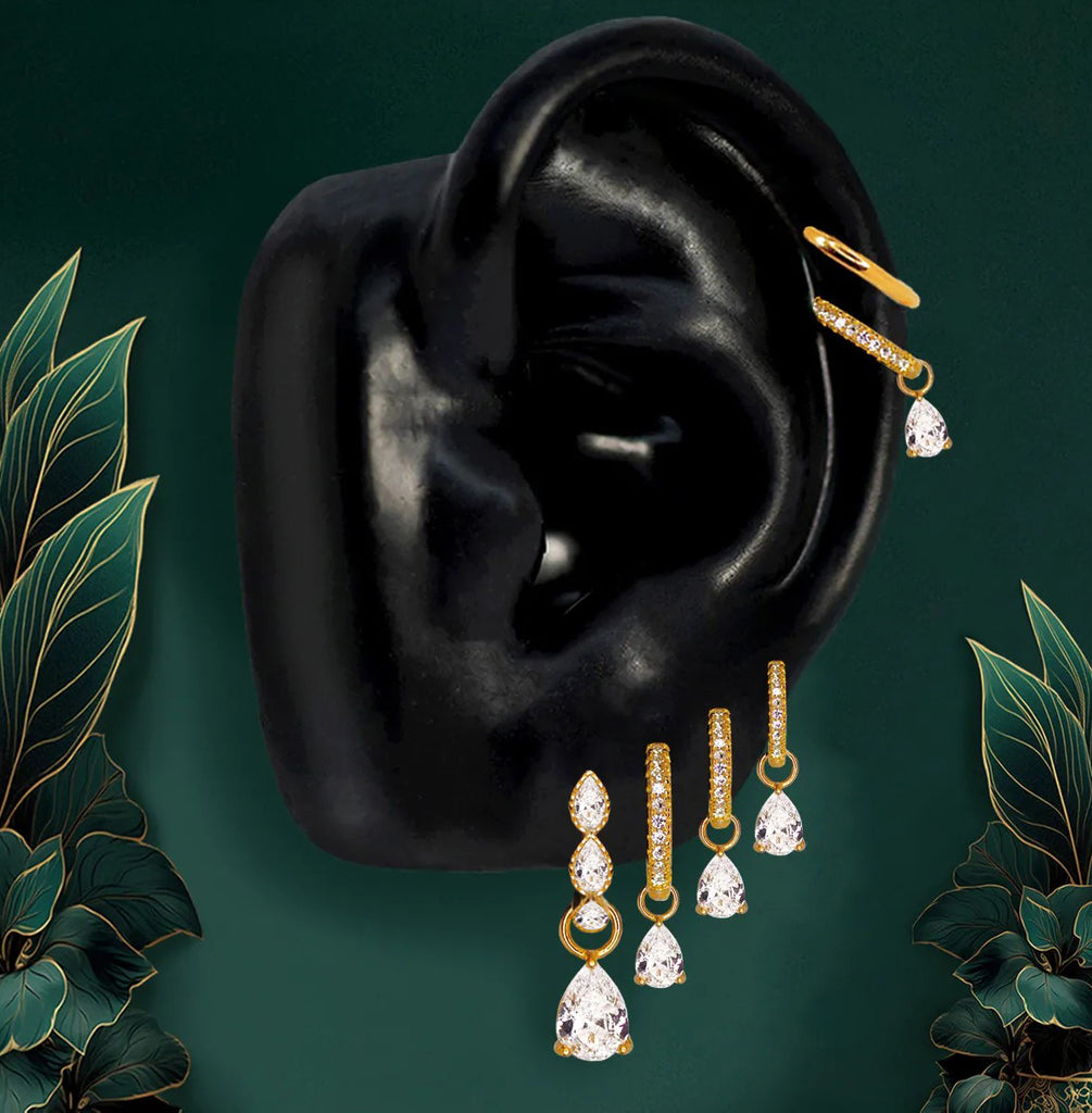 Elegant earring stack with gold hoop earrings and dangle stones