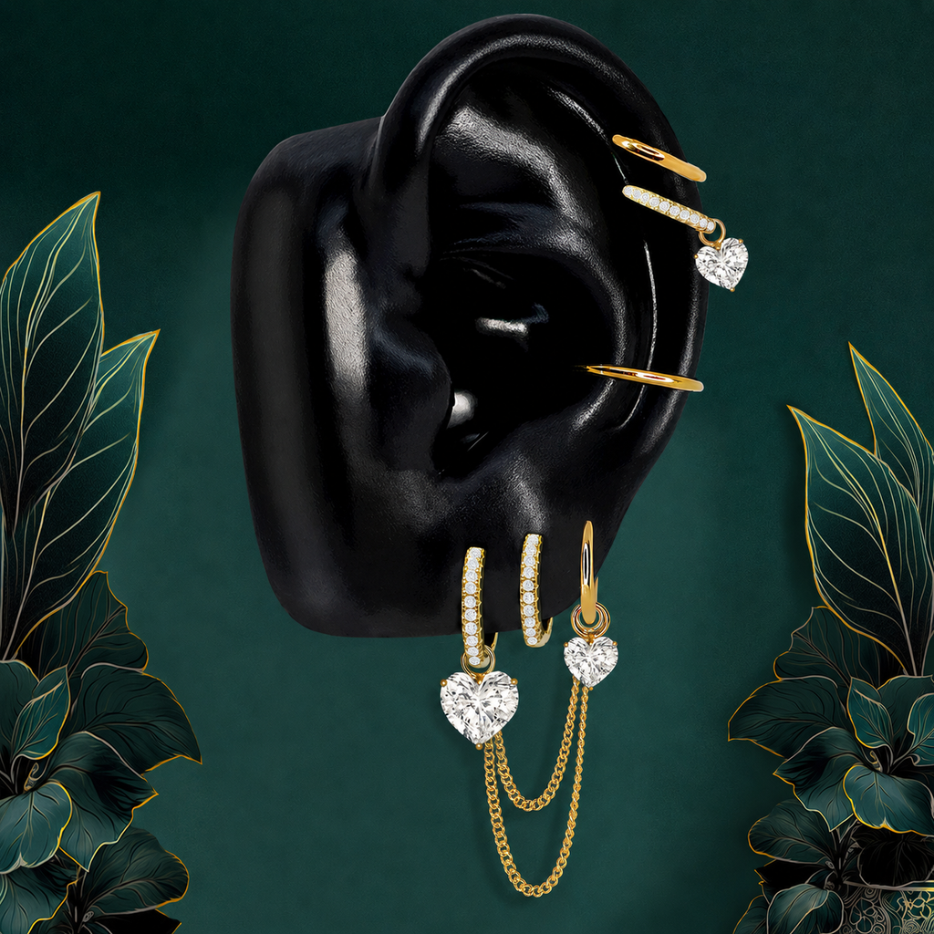 IMBER Elysian Heart earring stack in gold titanium with heart drops and chains, on display