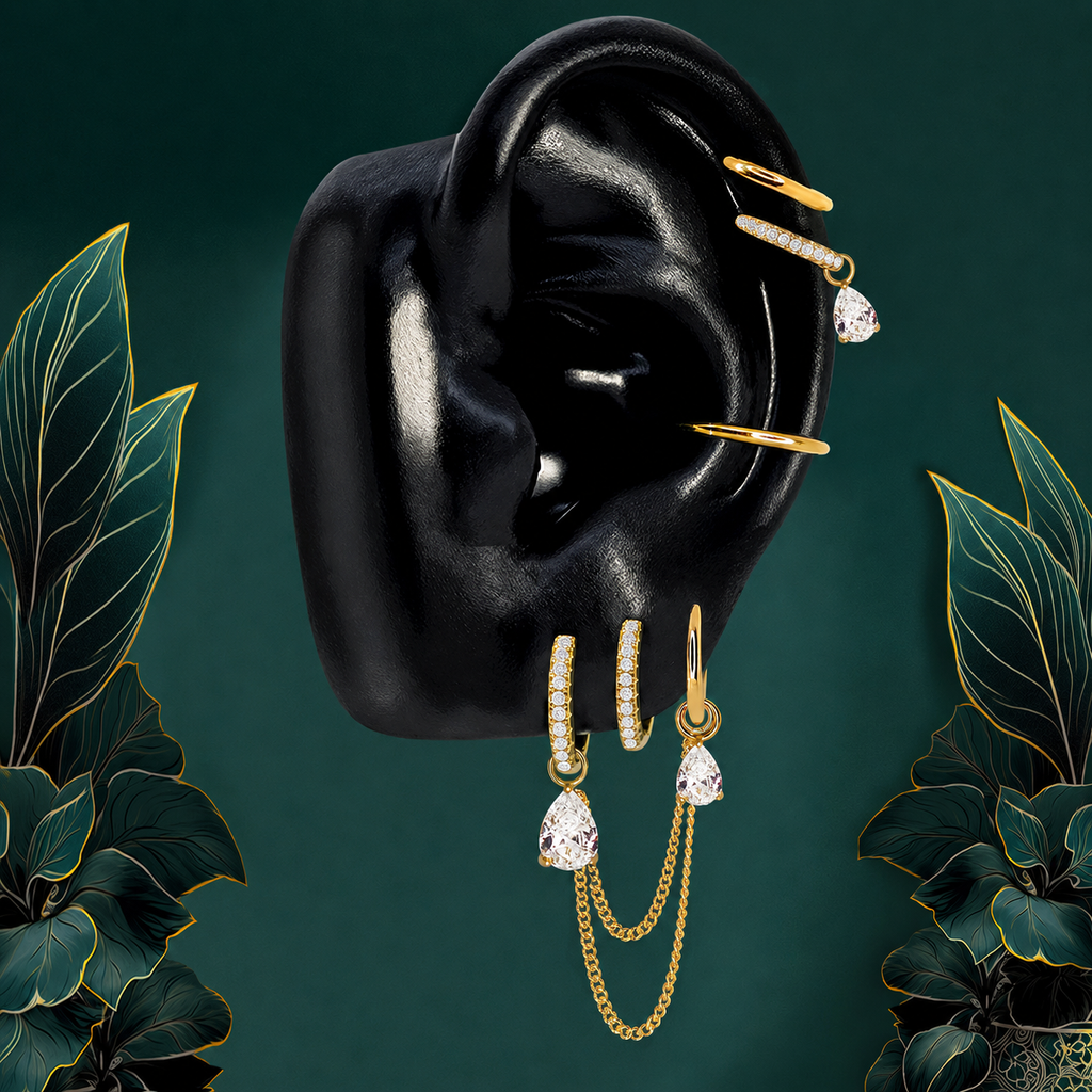 IMBER Elysian Pear earring stack in gold titanium with pear drops and chains, on display