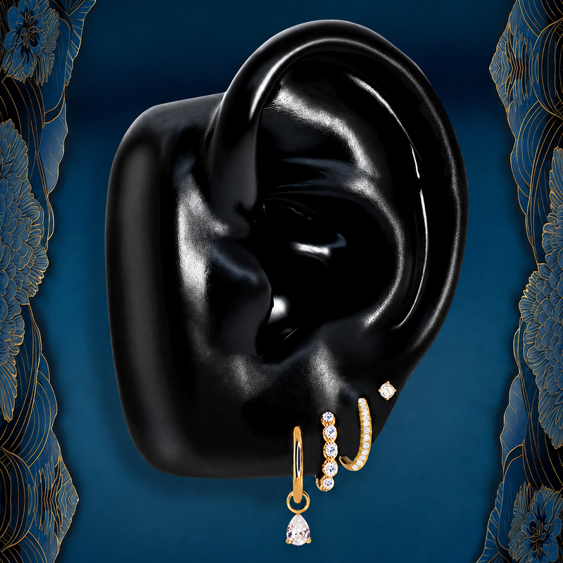 Emberlit gold earring stack on a black silicone ear display