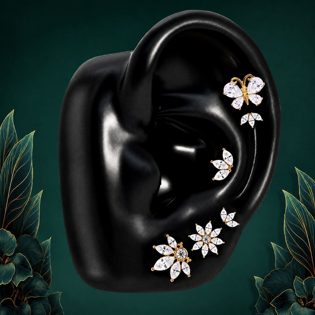 IMBER Enchanting earring stack in gold sterling silver with butterfly and floral studs, on display