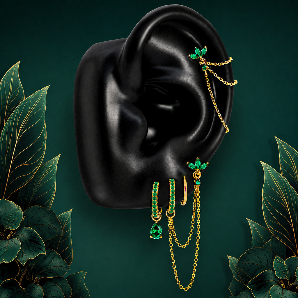 IMBER Eternal Green earring stack in gold titanium with green stones and chains, on display