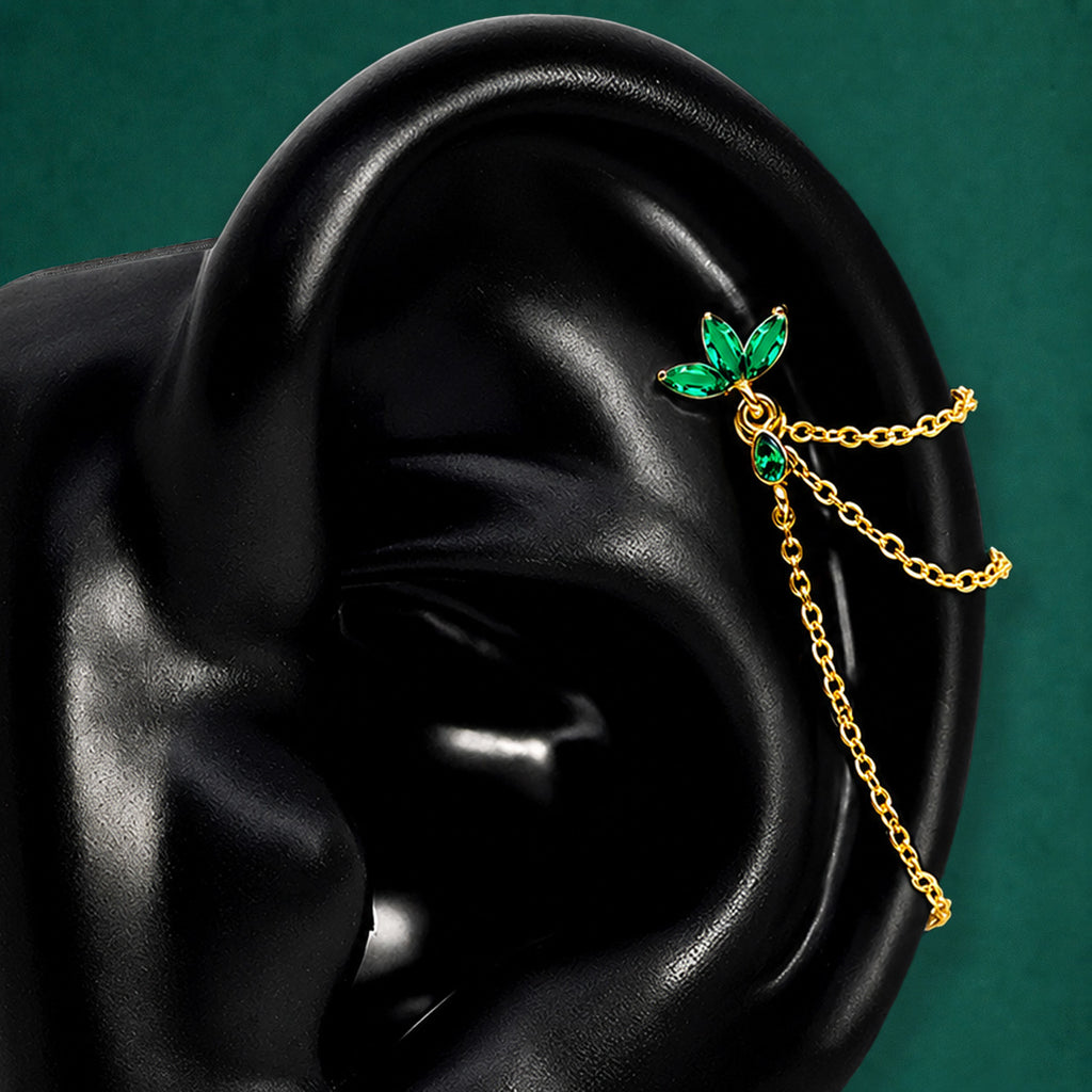 IMBER Eternal Helix Green floral stud in gold with green stones and chains, on display