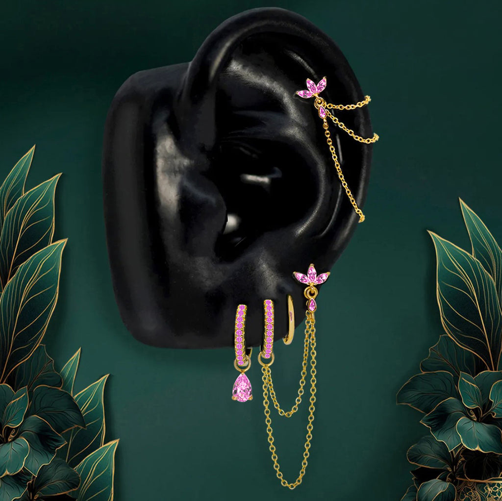 IMBER Eternal Pink earring stack in gold titanium with pink stones and chains, on display
