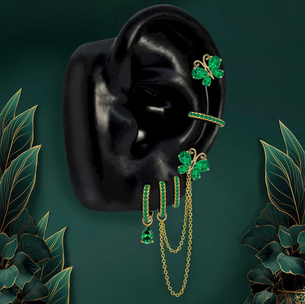Gold butterfly dangle earrings with green stones and chains