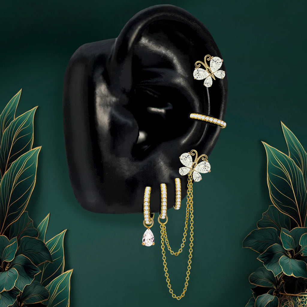 Gold butterfly earrings with white gems and chain drops