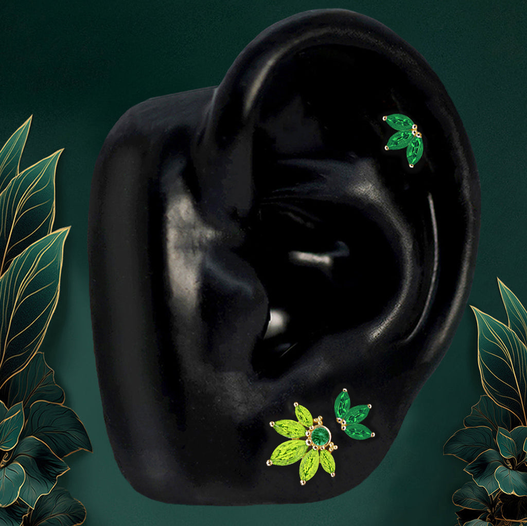Gold flower earrings with emerald-inspired green stones