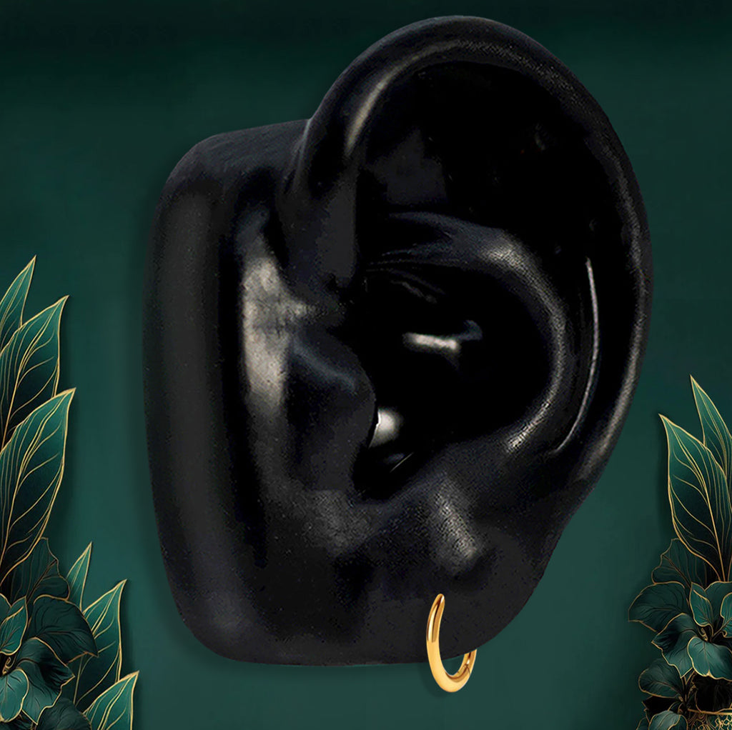 Dainty 10mm gold huggie earrings made from implant-grade titanium, perfect for first hole piercings