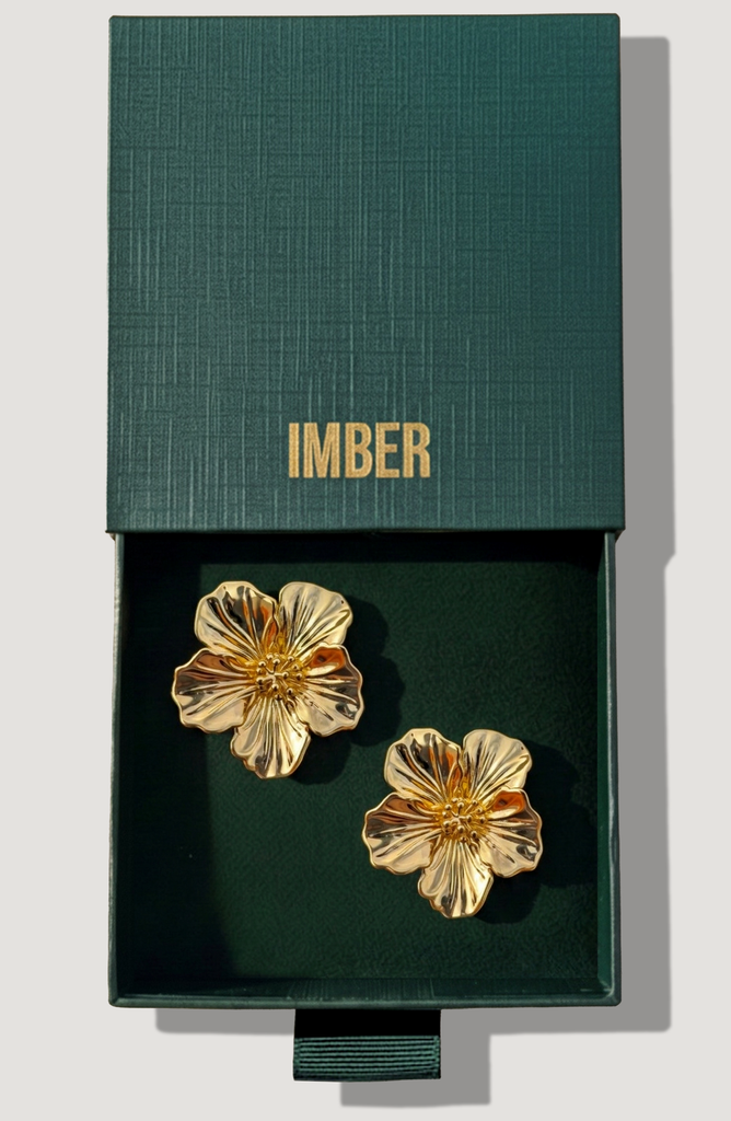 IMBER Hibiscus gold flower stud earrings in open green gift box, top view