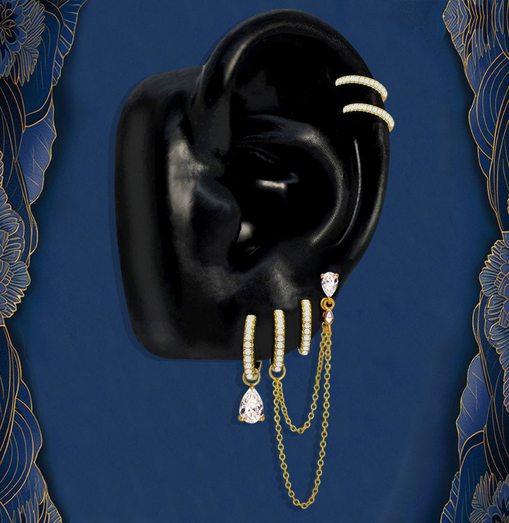Elegant hoop earrings with gold chains and teardrop charms for a modern ear stack look