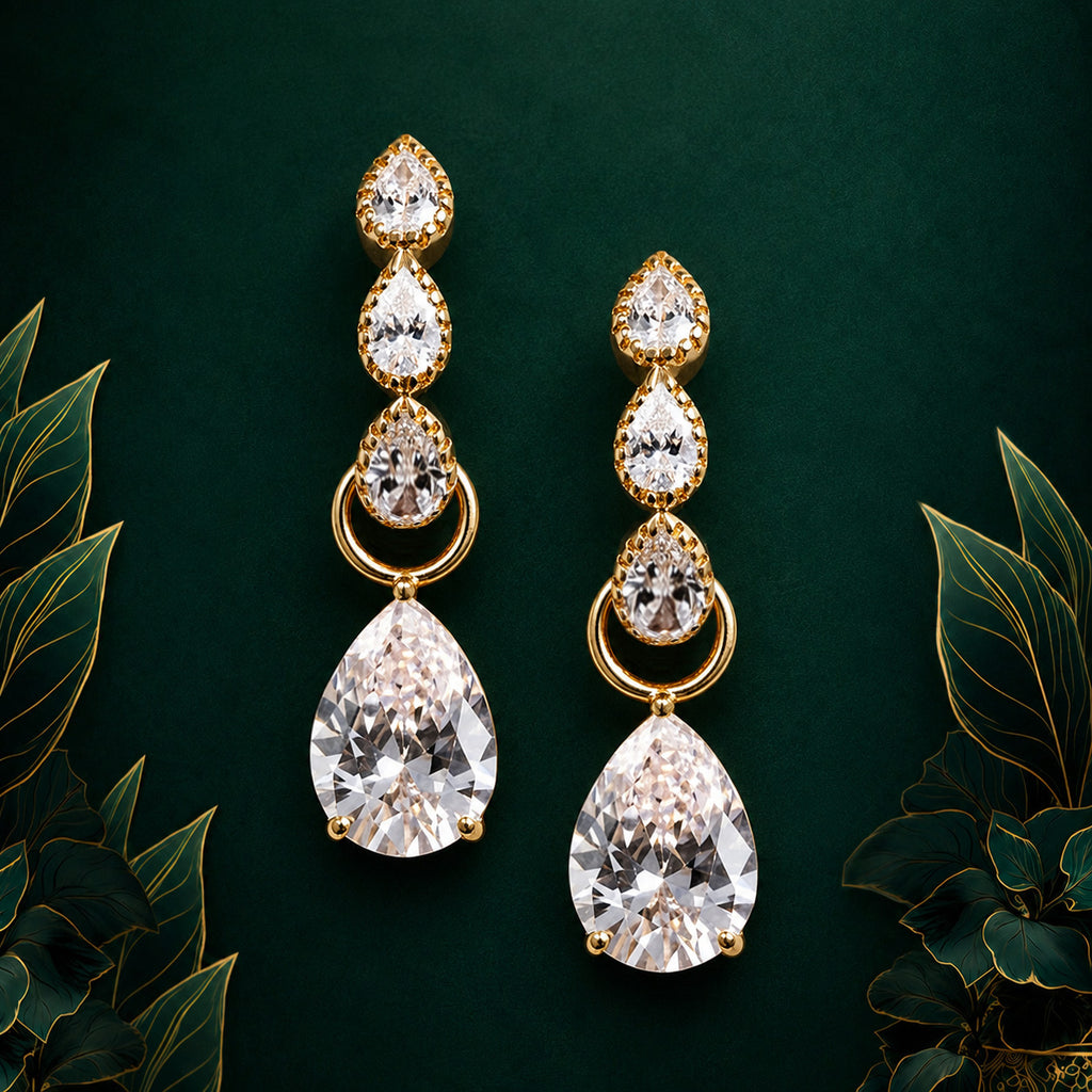 IMBER Luminary No.1 drop earrings in gold with pear-shaped crystals, on display