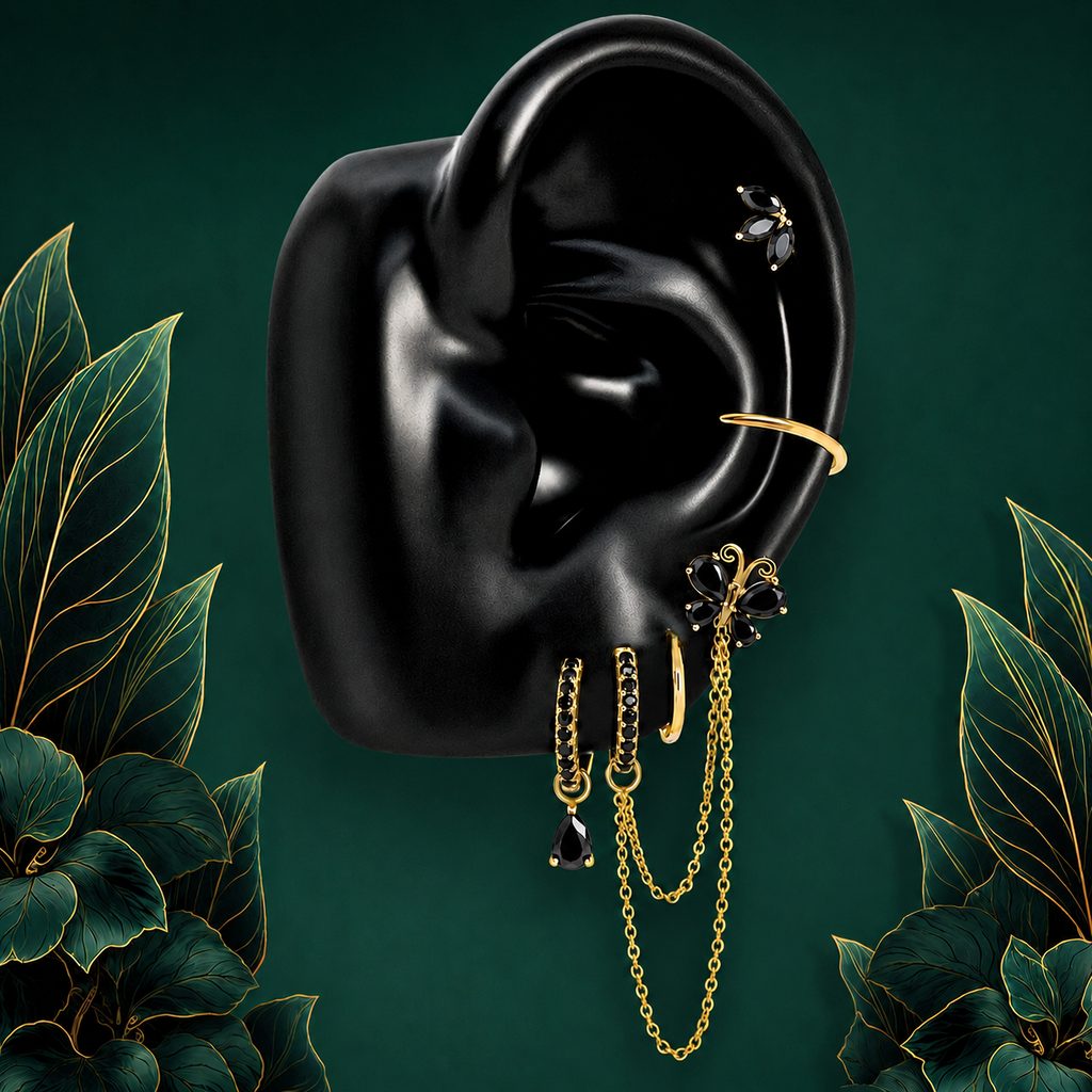 IMBER Metamorphosis Black earring stack in gold with black butterflies and chains, on display